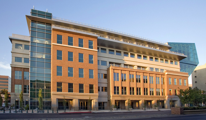 Modern office building with glass and brick facade.