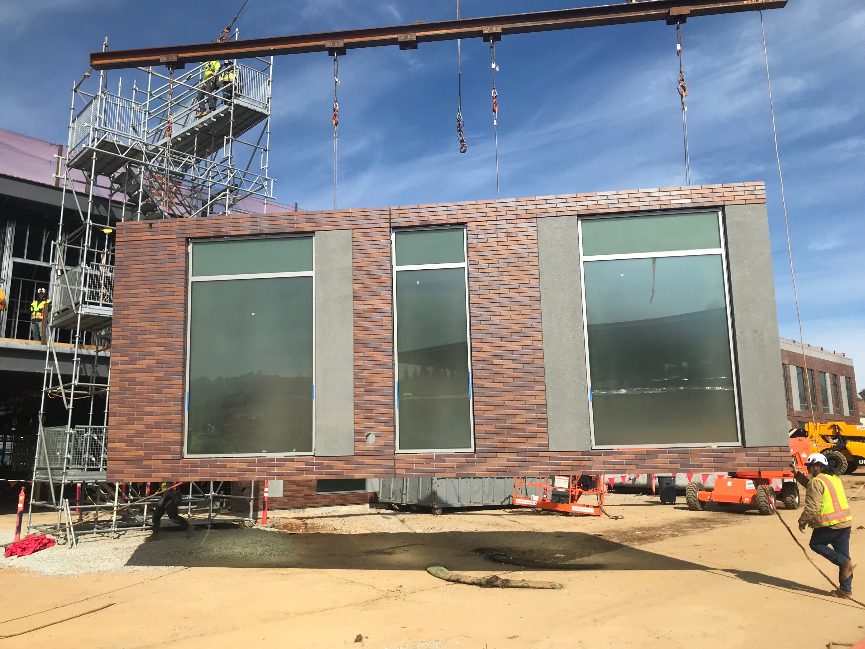 Worker moving panel on Placer County Health and Human Services Center with Infinite Facade