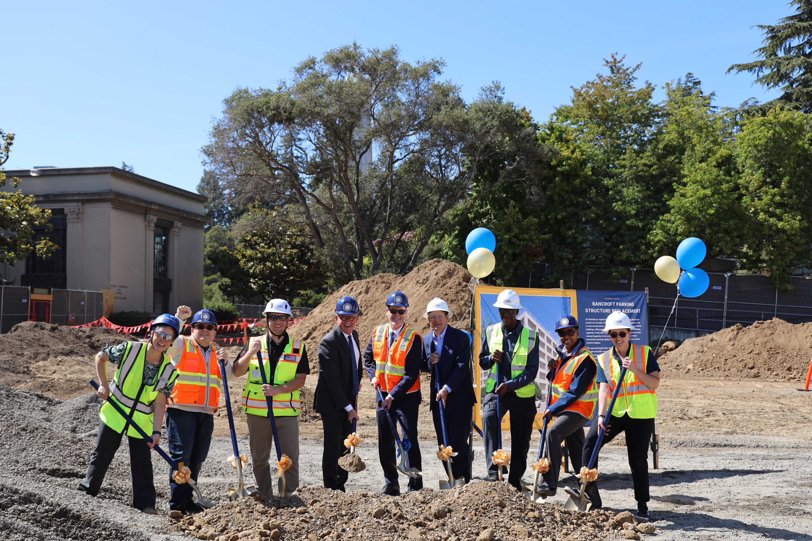 A group of people wearing hard hats on a construction site.